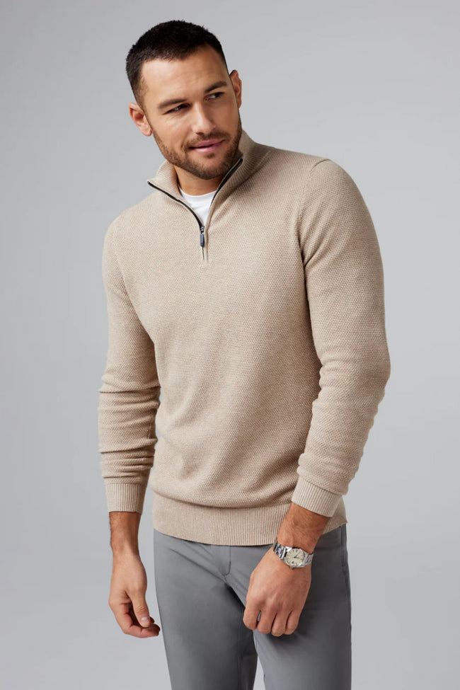 Man wears a cream half zip