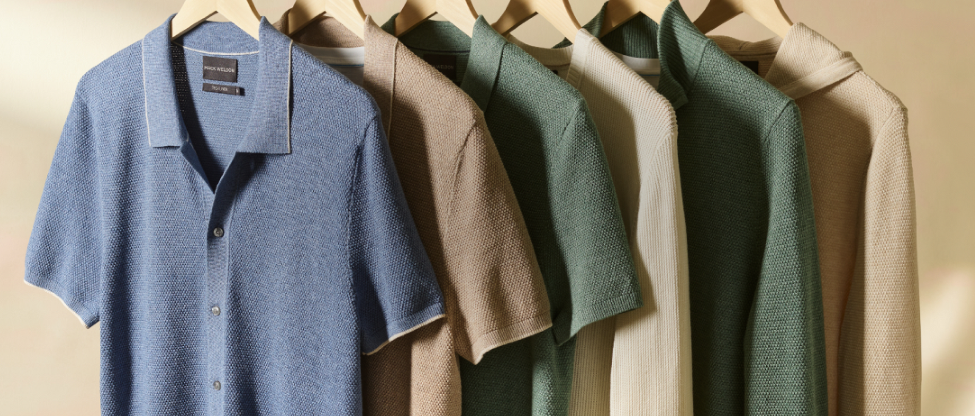 Image of different style and color tech linen tops hanging on a rack