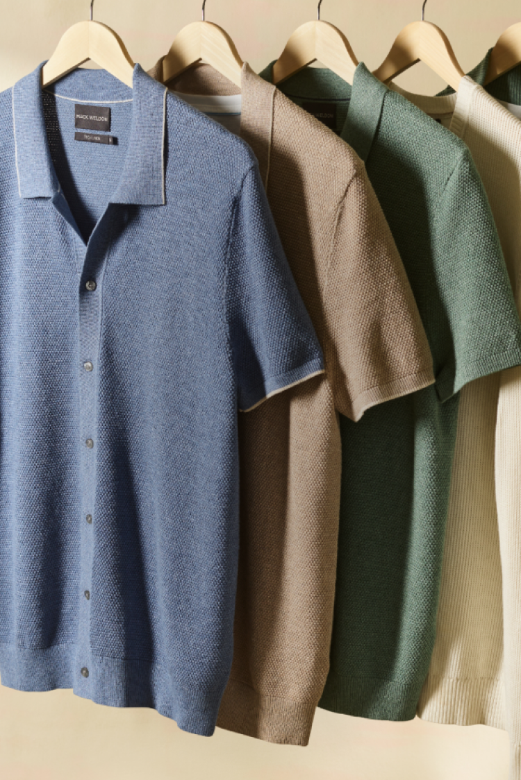 Image of different style and color tech linen tops hanging on a rack